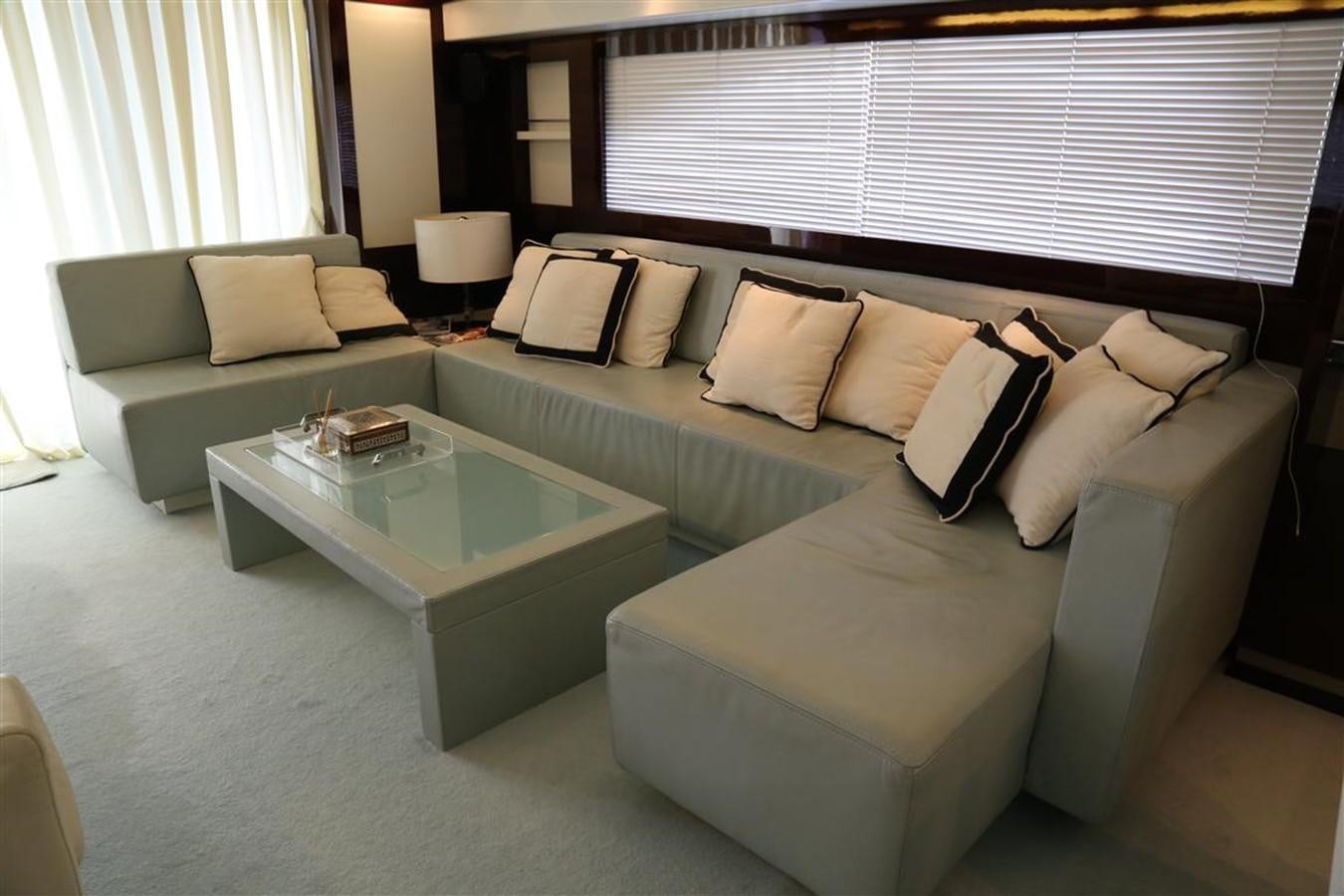 a living room with a couch and a coffee table aboard AMER 86 Yacht for Sale