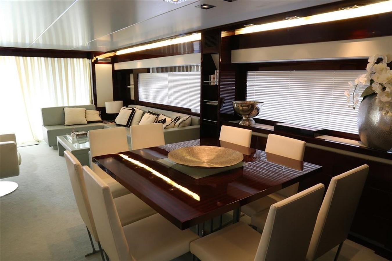 a living room with a table and chairs aboard AMER 86 Yacht for Sale
