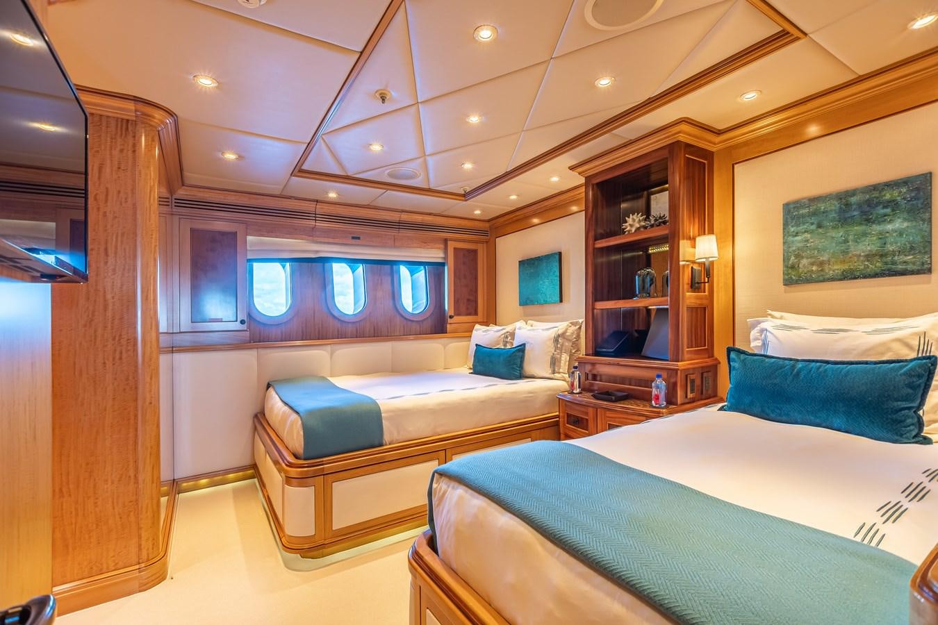 a room with a couple of beds aboard UNBRIDLED Yacht for Charter
