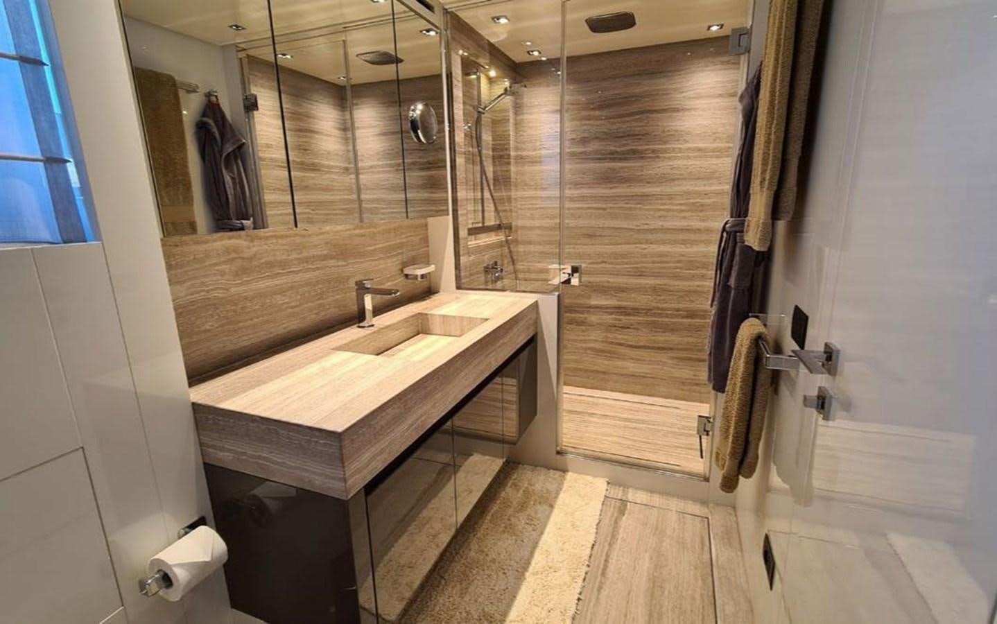a bathroom with a countertop sink and mirror aboard 2021 SANLORENZO SD96 #95 Yacht for Sale