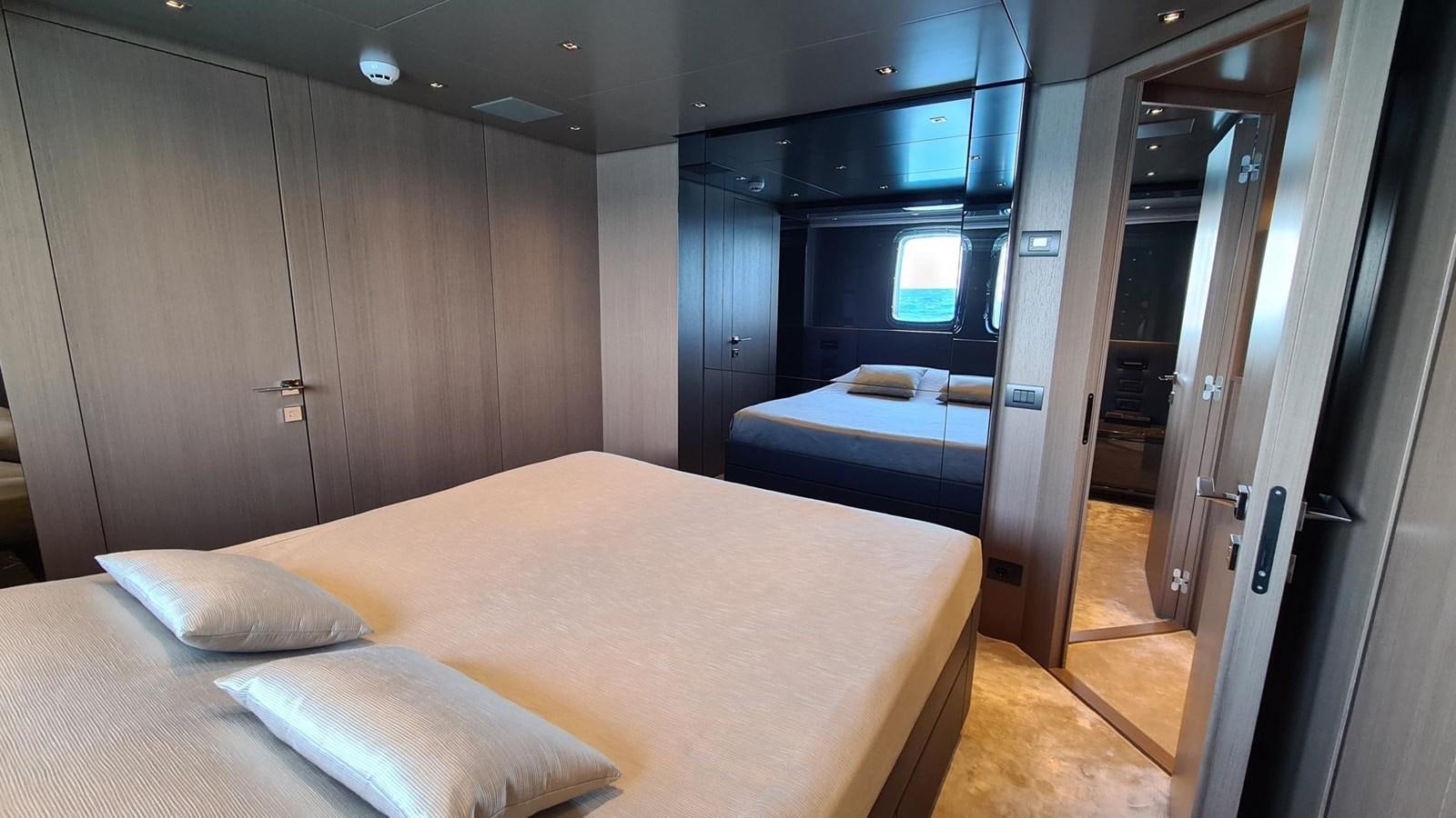 a room with a bed and a desk aboard 2021 SANLORENZO SD96 #95 Yacht for Sale