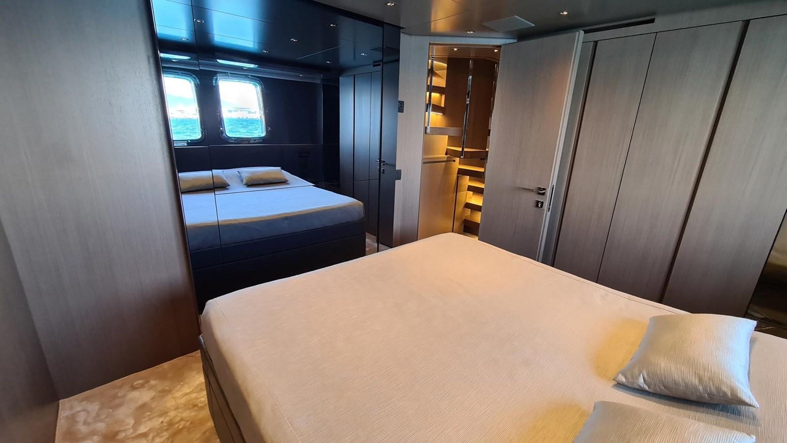 a room with a bed and a closet aboard 2021 SANLORENZO SD96 #95 Yacht for Sale