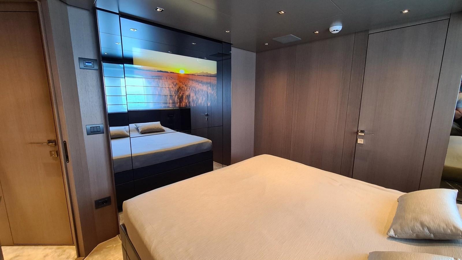 a room with a bed and a mirror aboard 2021 SANLORENZO SD96 #95 Yacht for Sale