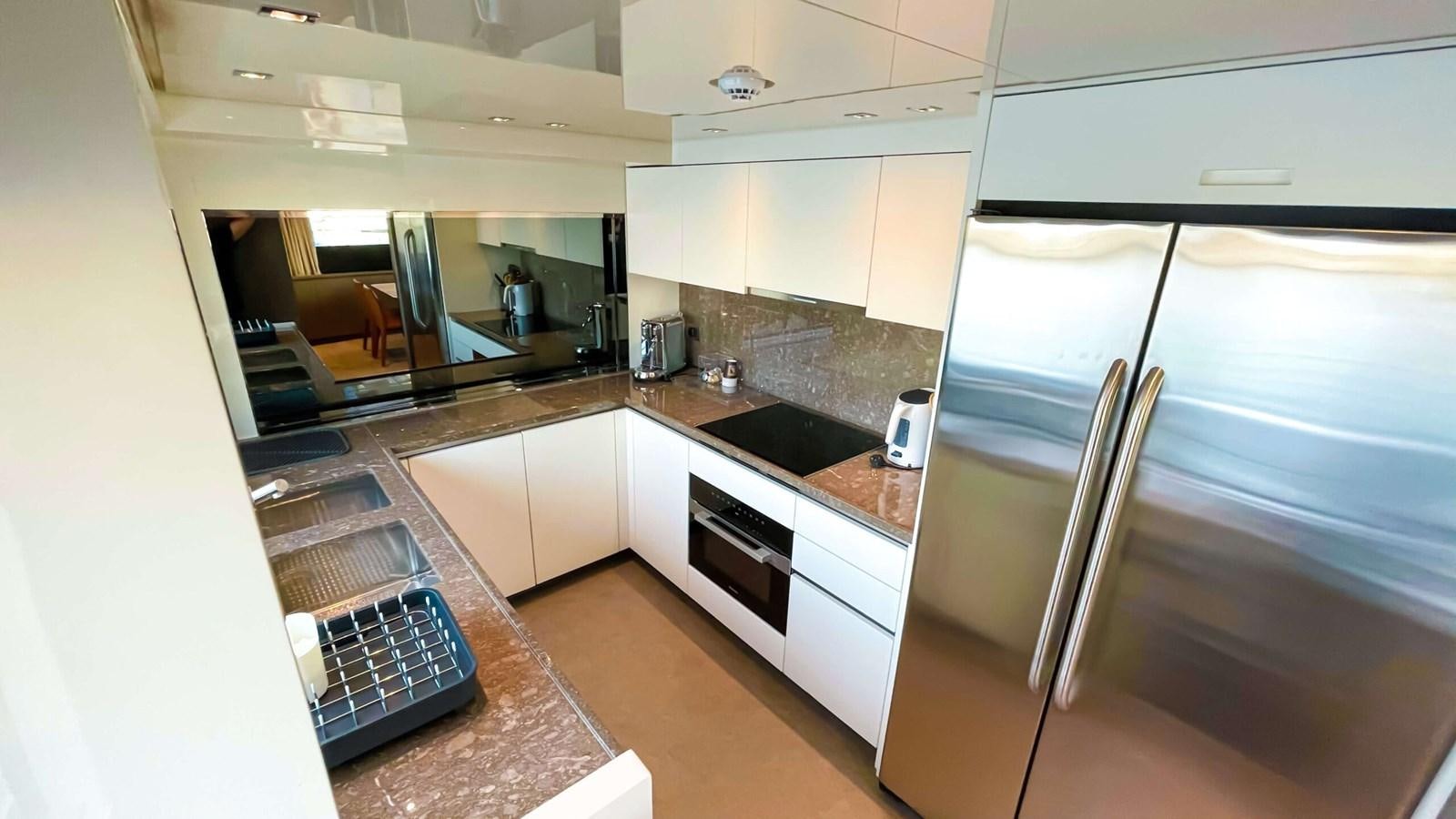 a kitchen with a stainless steel stove aboard 2021 SANLORENZO SX88 #47 Yacht for Sale