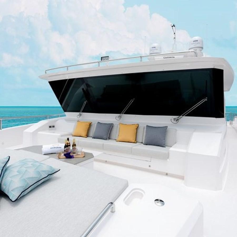 a white bed with a white bed and a white bed with a white and blue ocean and a aboard ONE MORE TIME Yacht for Sale