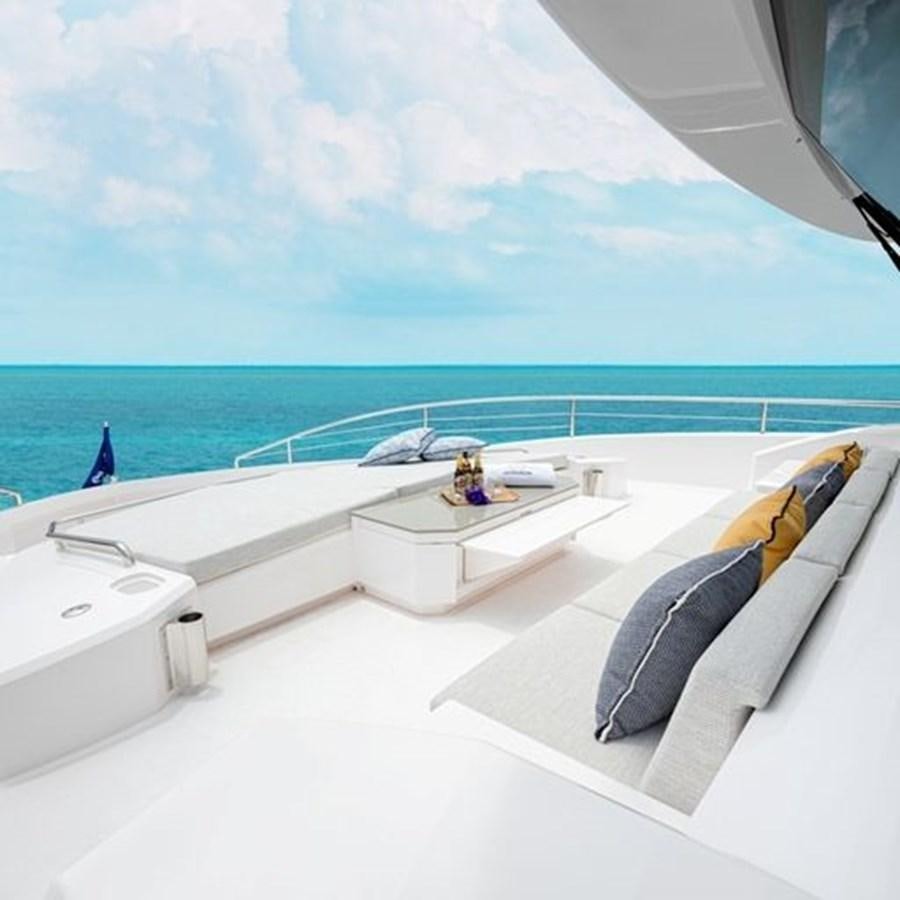 a room with a bed and a chair on a balcony aboard ONE MORE TIME Yacht for Sale