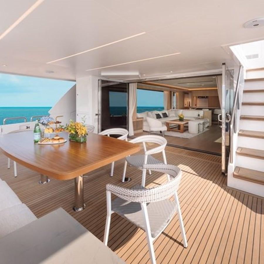 a modern looking kitchen with a large island and a large window aboard ONE MORE TIME Yacht for Sale