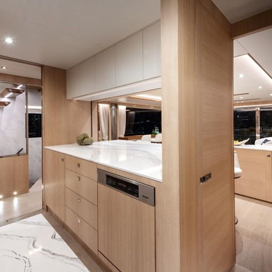 a kitchen with white cabinets aboard ONE MORE TIME Yacht for Sale