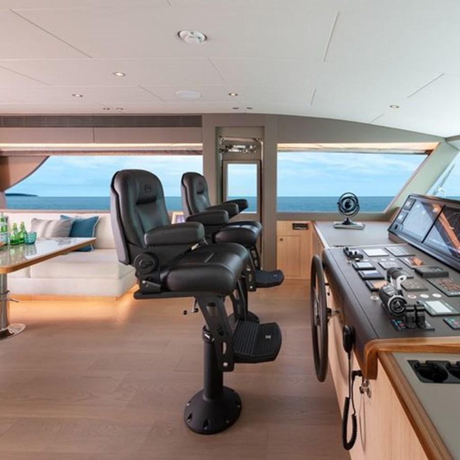 a room with a desk and chairs aboard ONE MORE TIME Yacht for Sale