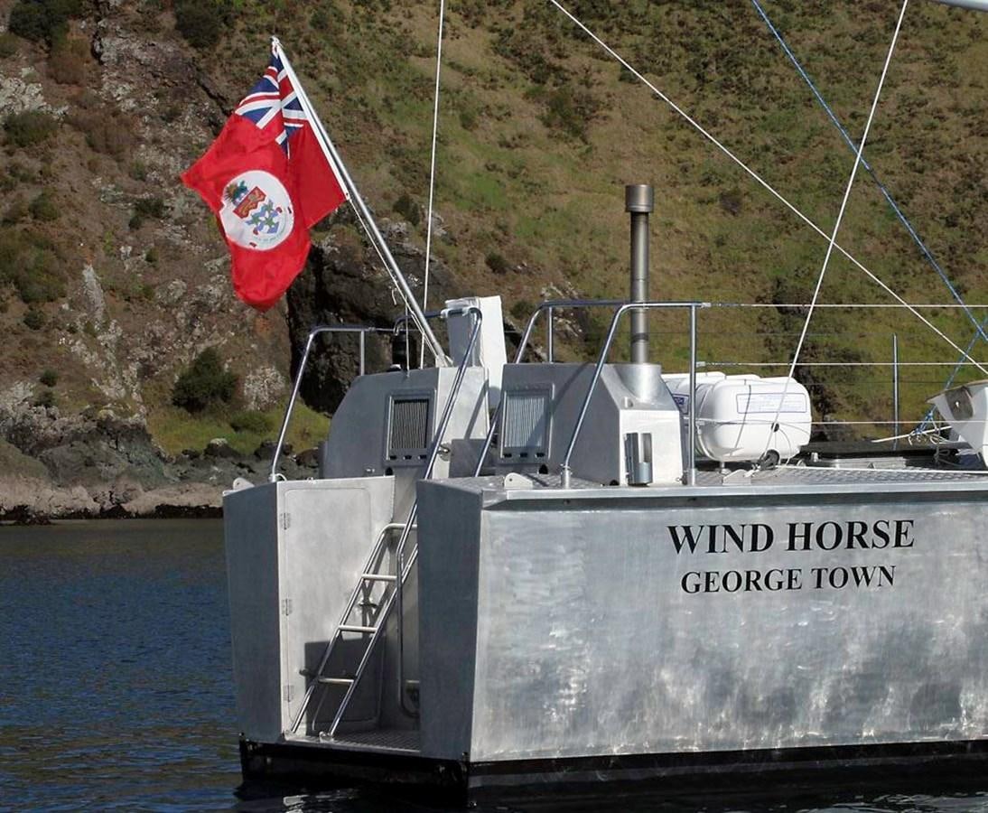 a large military ship with a flag on it aboard WIND HORSE Yacht for Sale