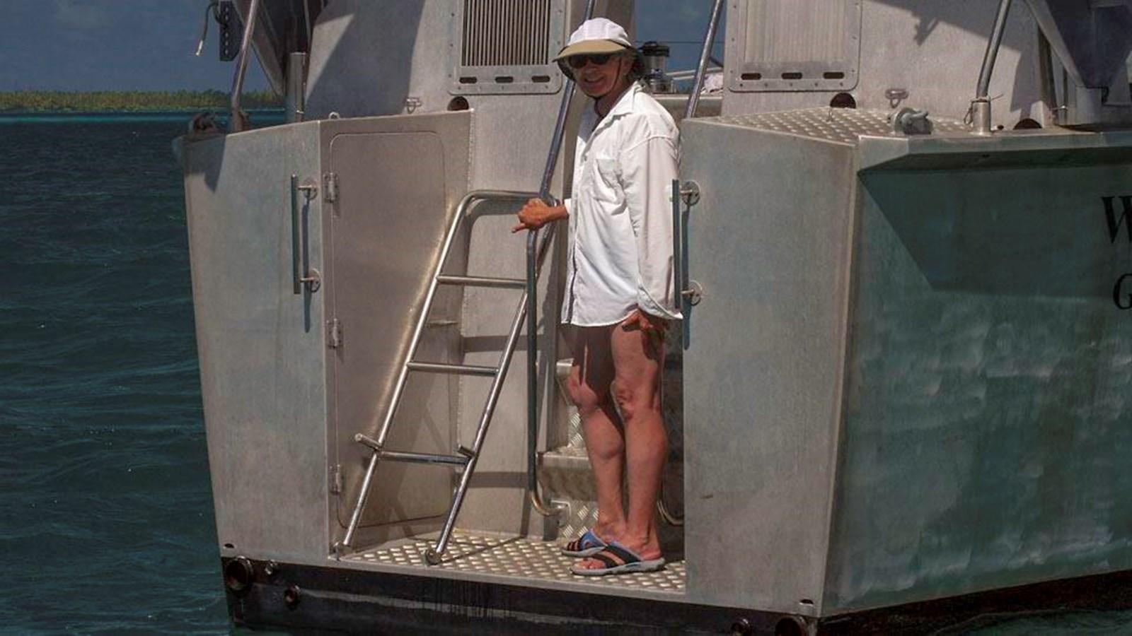 a man standing on a boat aboard WIND HORSE Yacht for Sale