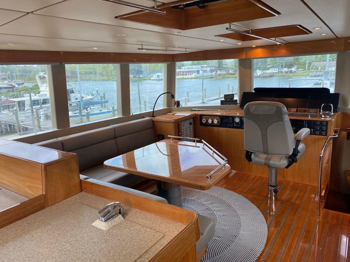 a room with a table and chairs aboard WIND HORSE Yacht for Sale