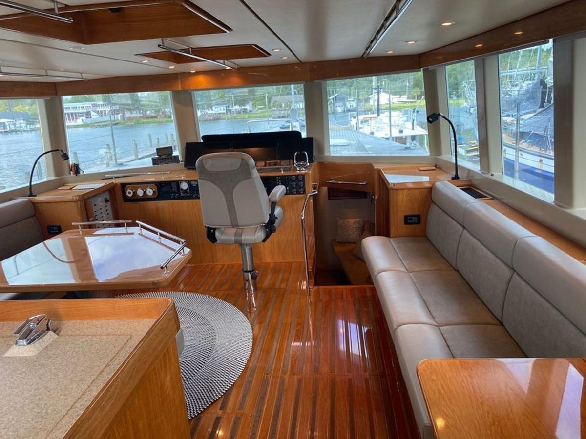 a room with a couch and a table and a chair aboard WIND HORSE Yacht for Sale