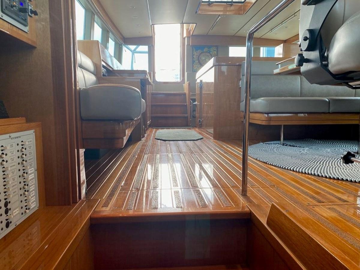 a room with wood floors and a staircase aboard WIND HORSE Yacht for Sale