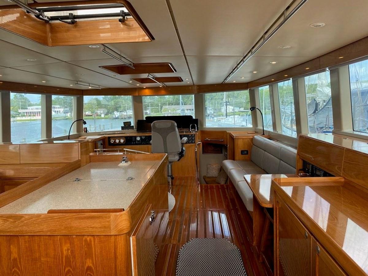 a room with tables and chairs aboard WIND HORSE Yacht for Sale