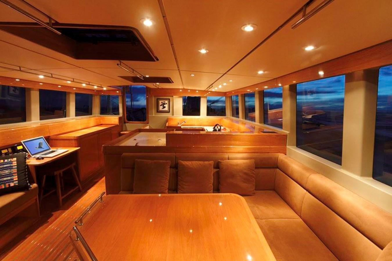 a living room with a couch and a laptop aboard WIND HORSE Yacht for Sale