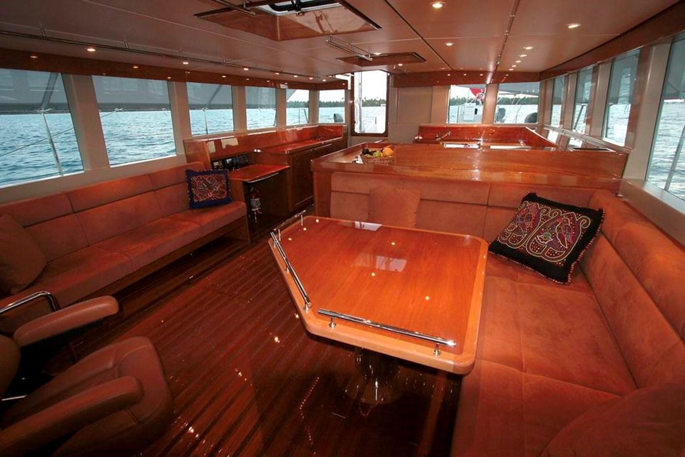 a living room with a couch and a table aboard WIND HORSE Yacht for Sale