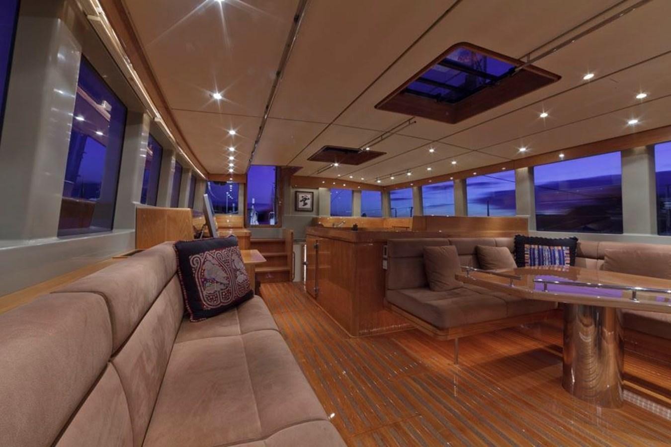 a living room with a large sofa aboard WIND HORSE Yacht for Sale