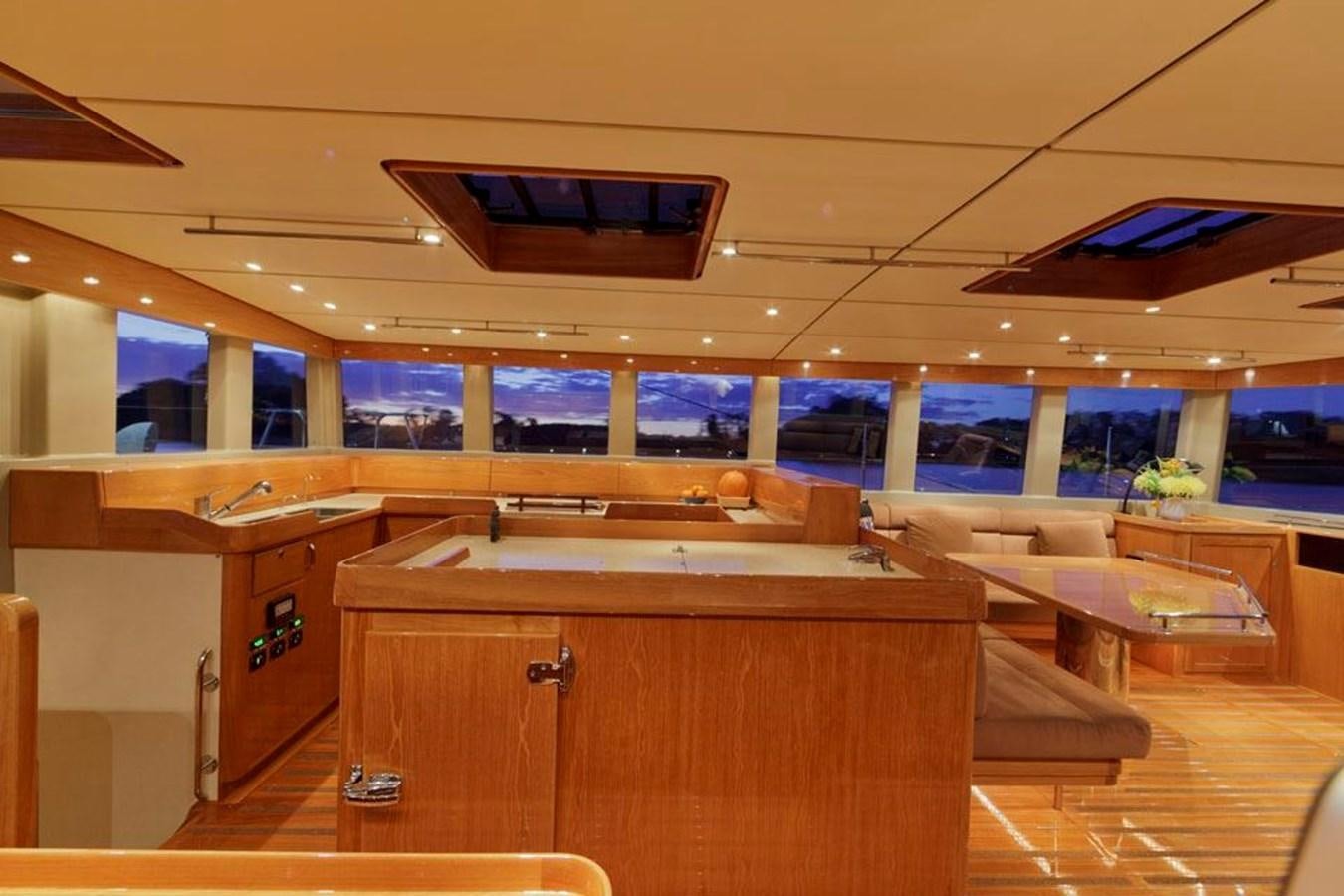 a room with a wood desk and a large window aboard WIND HORSE Yacht for Sale