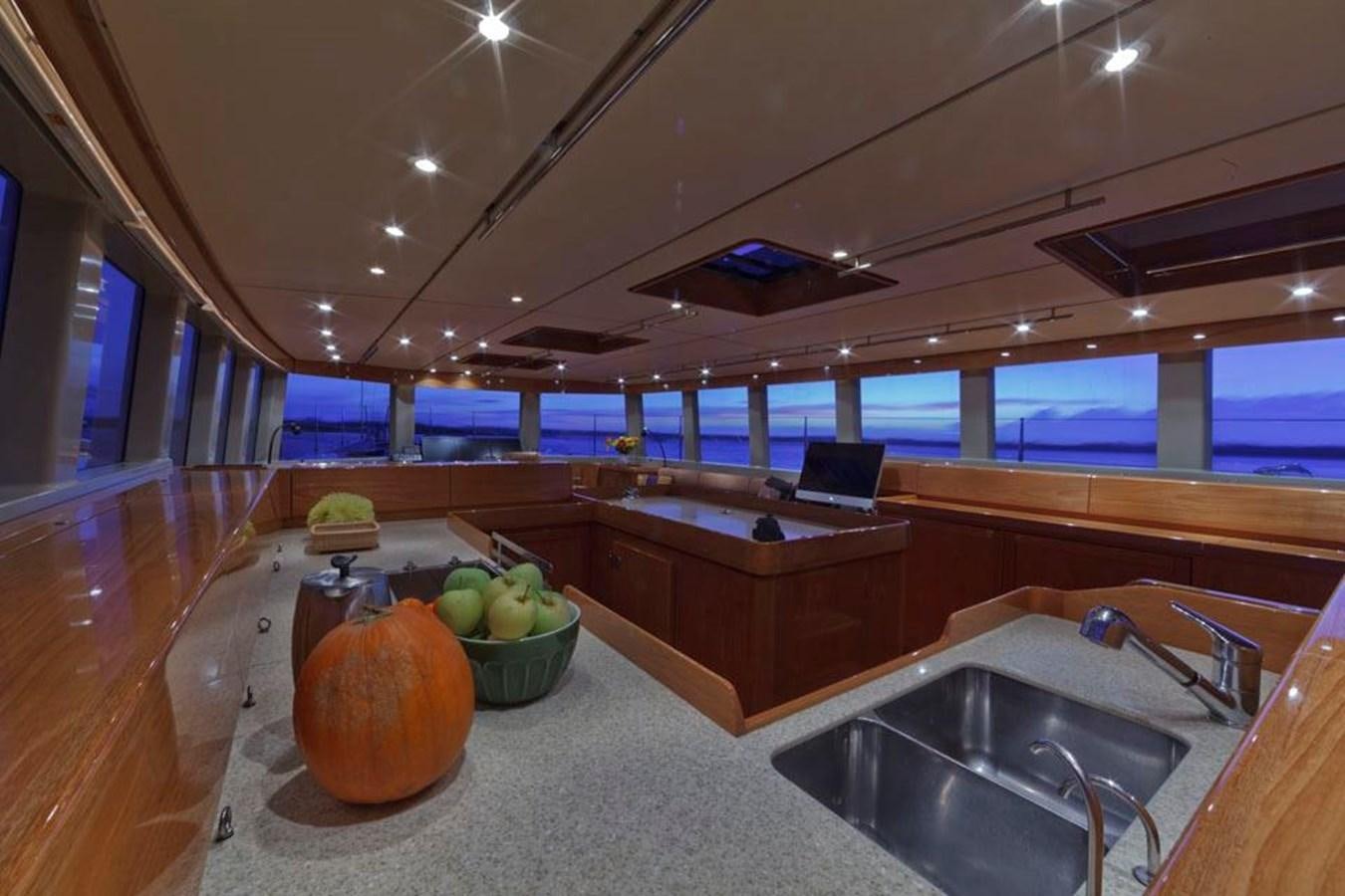 a kitchen with a large countertop and a large window aboard WIND HORSE Yacht for Sale