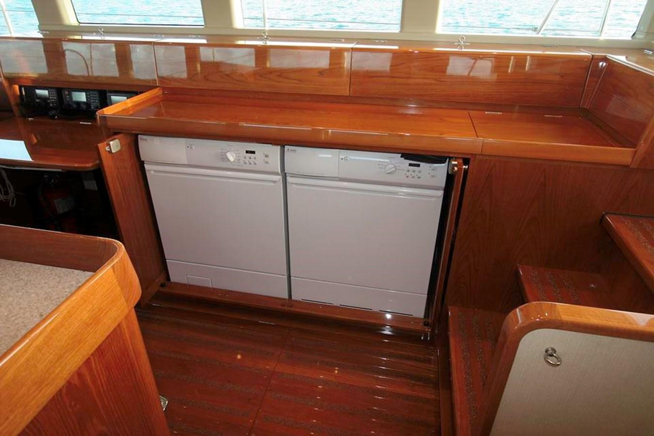 a kitchen with wooden cabinets aboard WIND HORSE Yacht for Sale