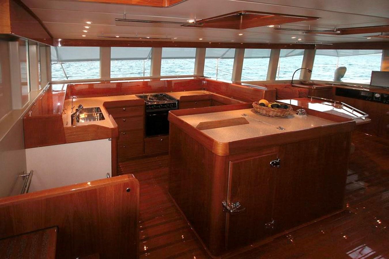 a kitchen with wooden cabinets aboard WIND HORSE Yacht for Sale
