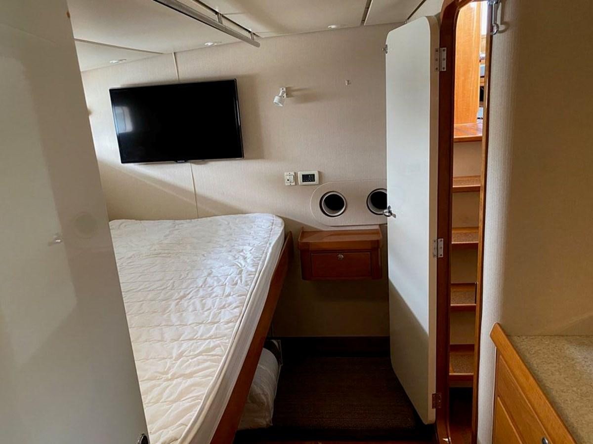 a bathroom with a bed and a window aboard WIND HORSE Yacht for Sale