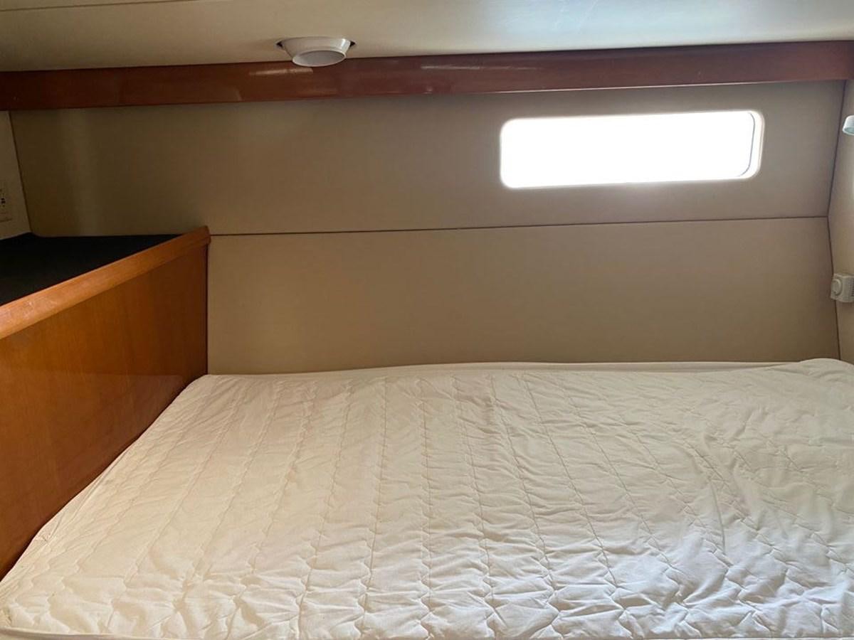 a bed with a white sheet aboard WIND HORSE Yacht for Sale