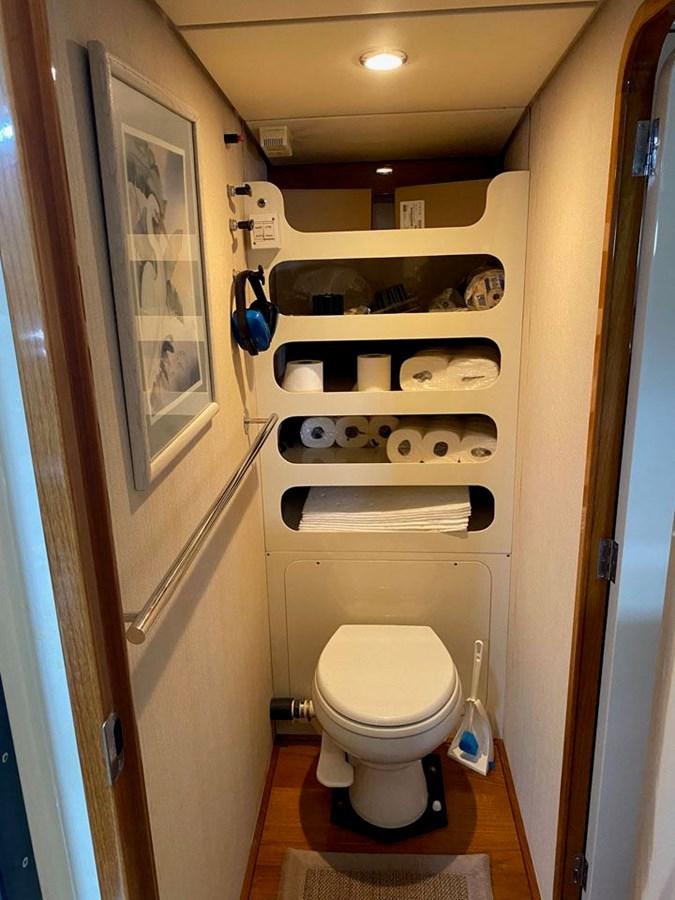 a toilet with a sink and a mirror above it aboard WIND HORSE Yacht for Sale