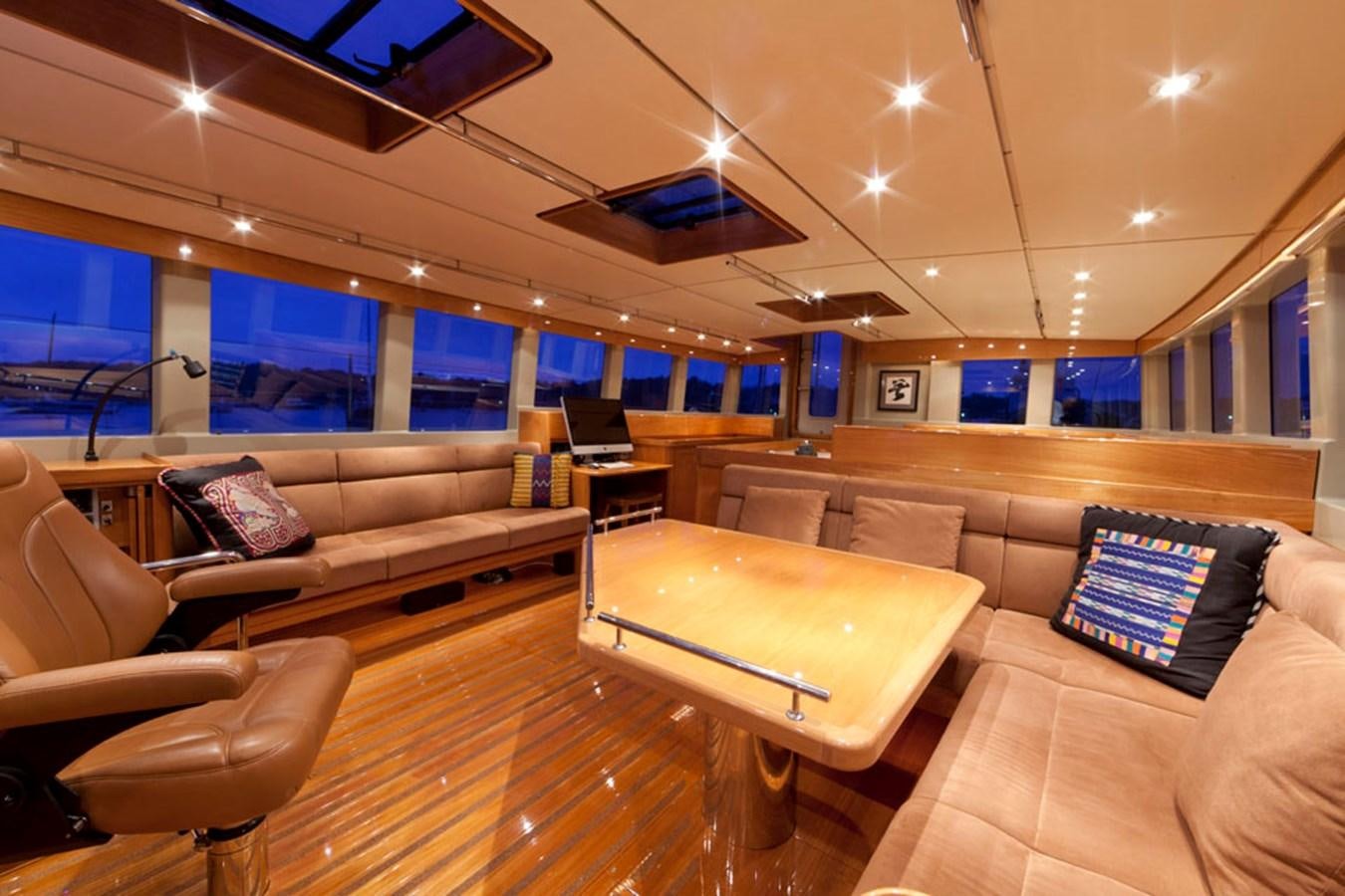 a living room with a couch and a table aboard WIND HORSE Yacht for Sale