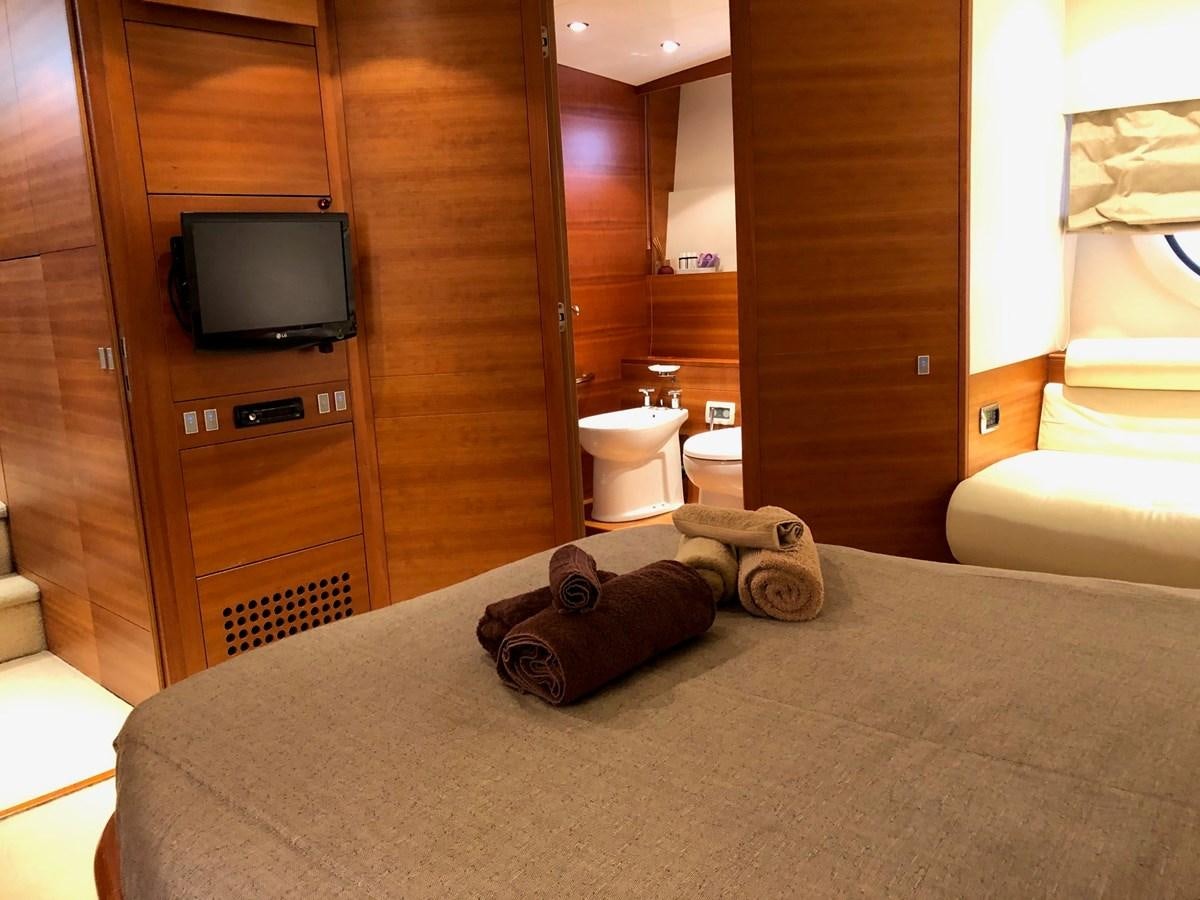 a hotel room with a tv and bed aboard JULY Yacht for Sale