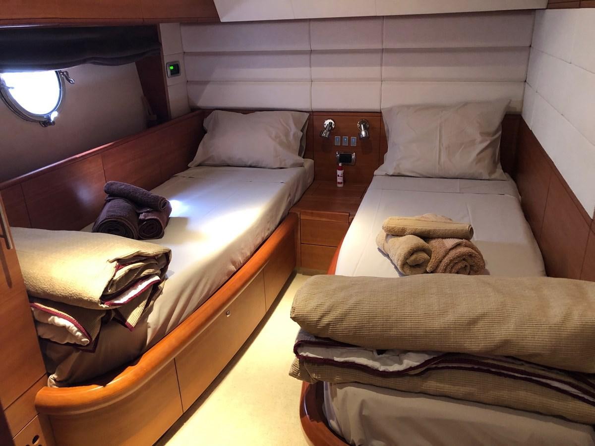 a couple of beds in a room aboard JULY Yacht for Sale