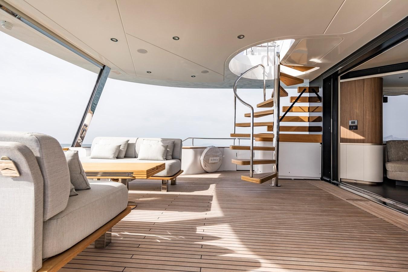 a living room with a staircase and a couch aboard ANDALA Yacht for Sale