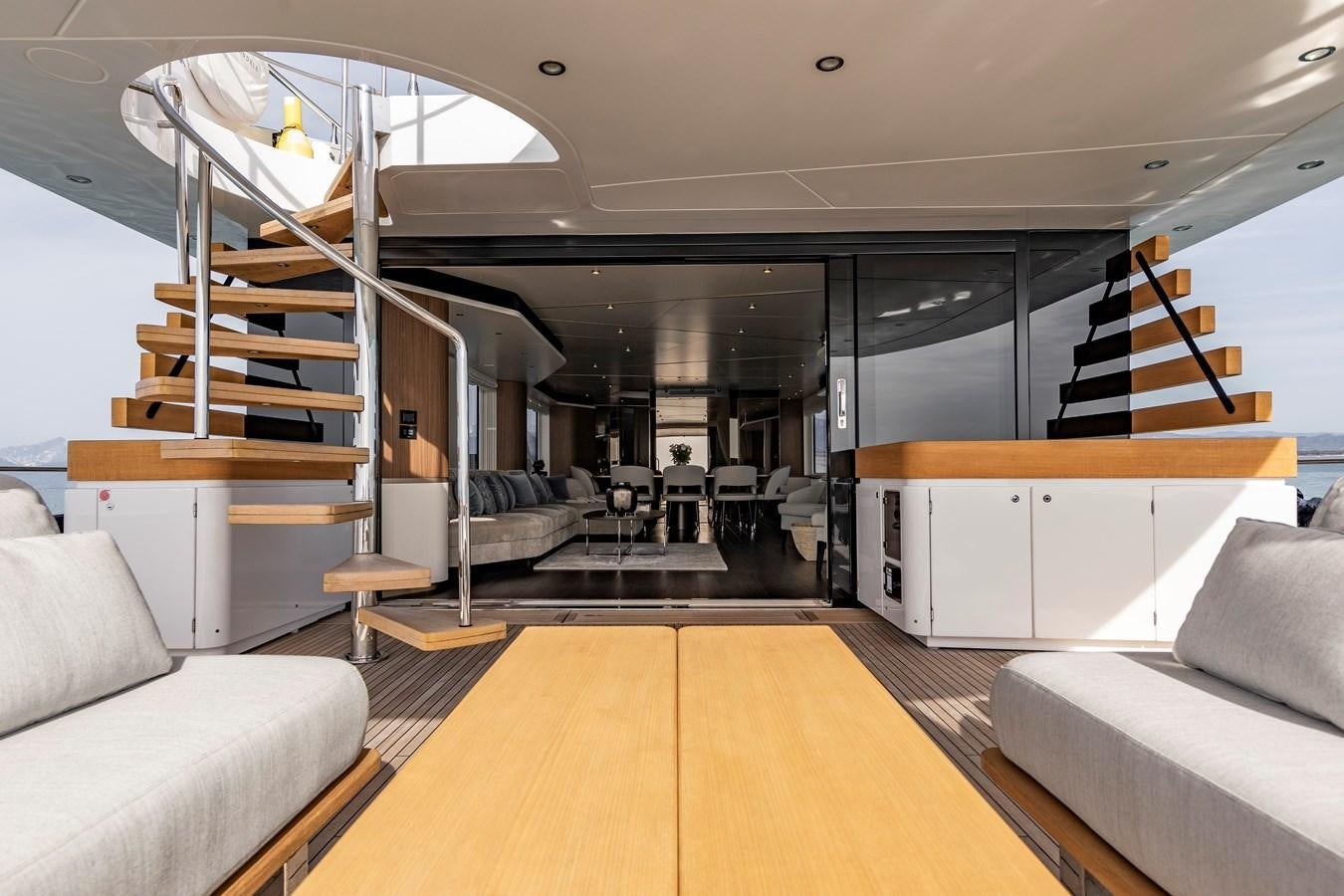 a room with a couch and a staircase aboard ANDALA Yacht for Sale