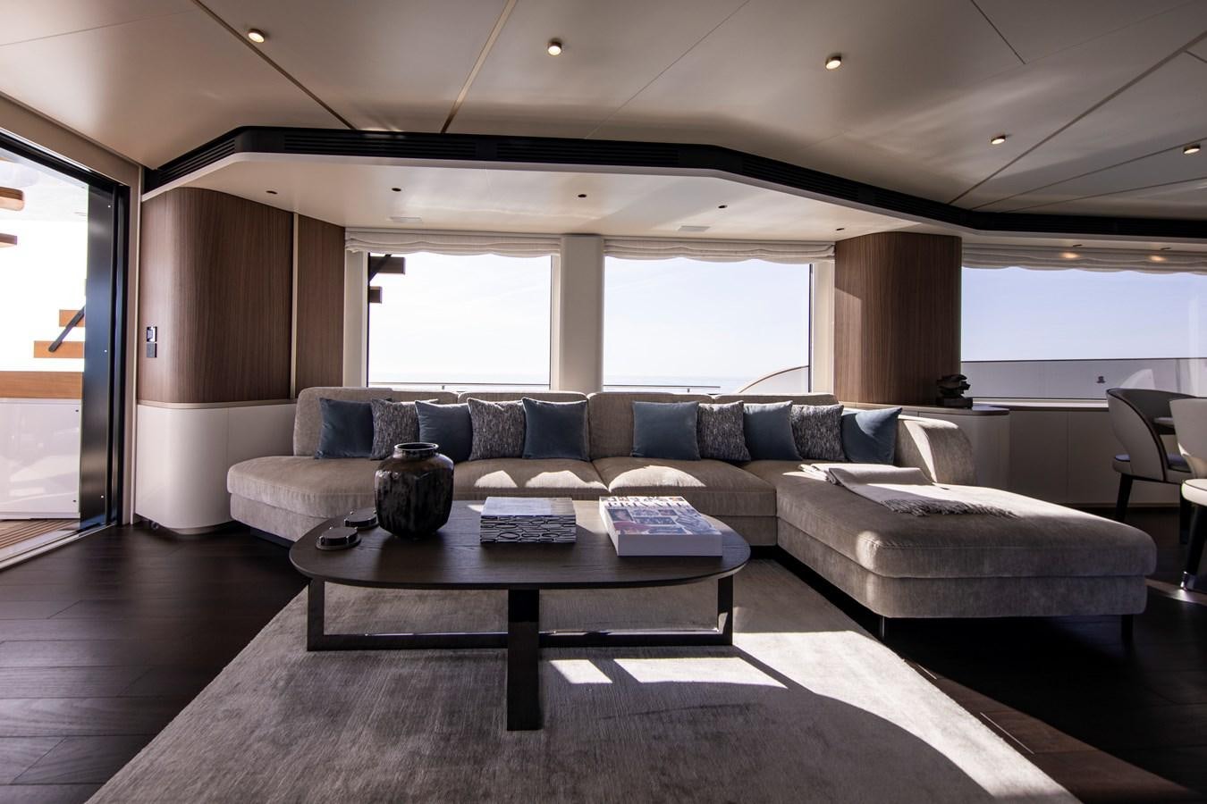a living room with a couch and a coffee table aboard ANDALA Yacht for Sale
