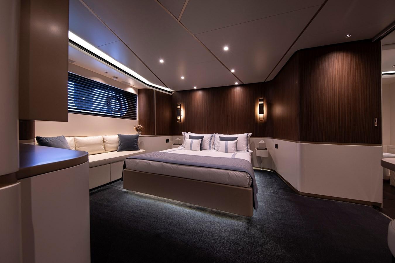 a room with a bed and a desk aboard ANDALA Yacht for Sale