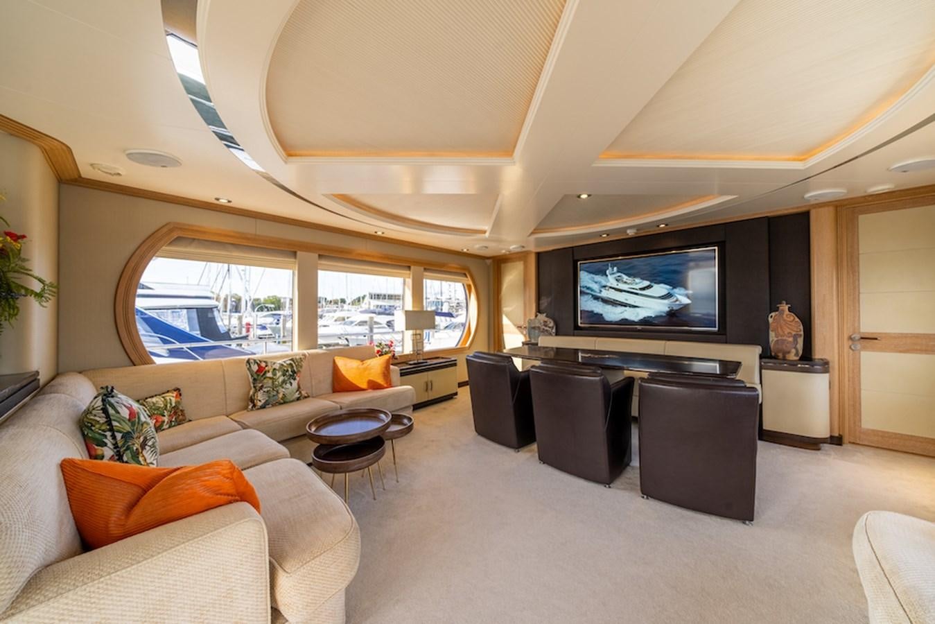 a living room with a large television aboard LA MASCARADE Yacht for Sale