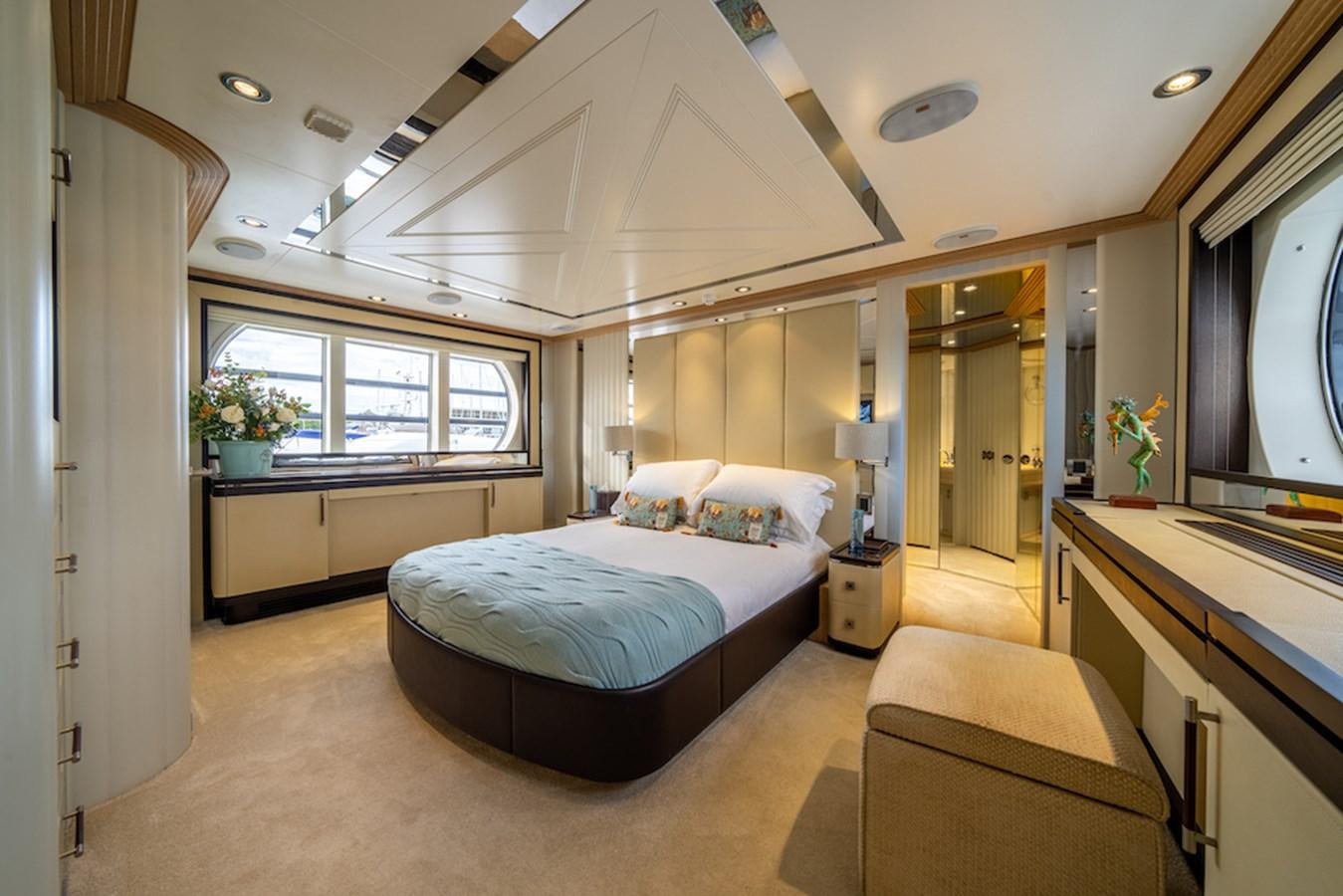 a large bedroom with a large bed aboard LA MASCARADE Yacht for Sale