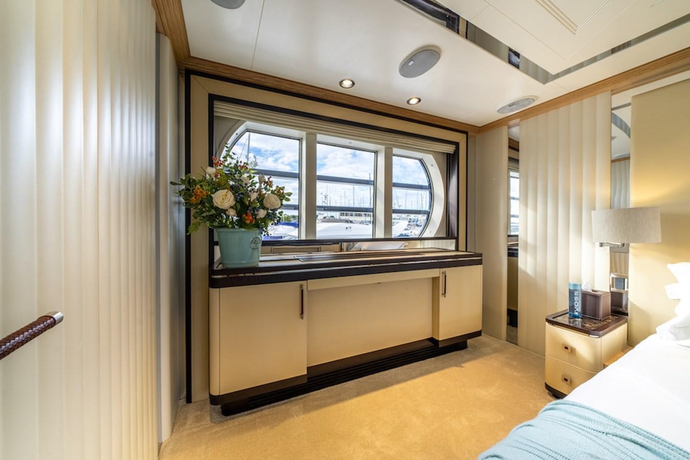 a room with a bed and a window aboard LA MASCARADE Yacht for Sale