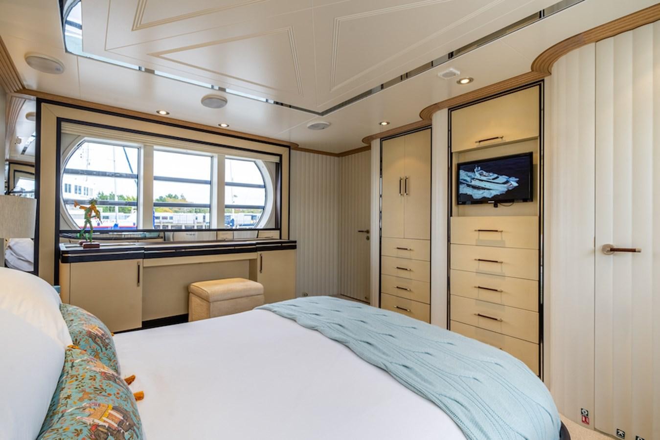 a bedroom with a bed and a television aboard LA MASCARADE Yacht for Sale