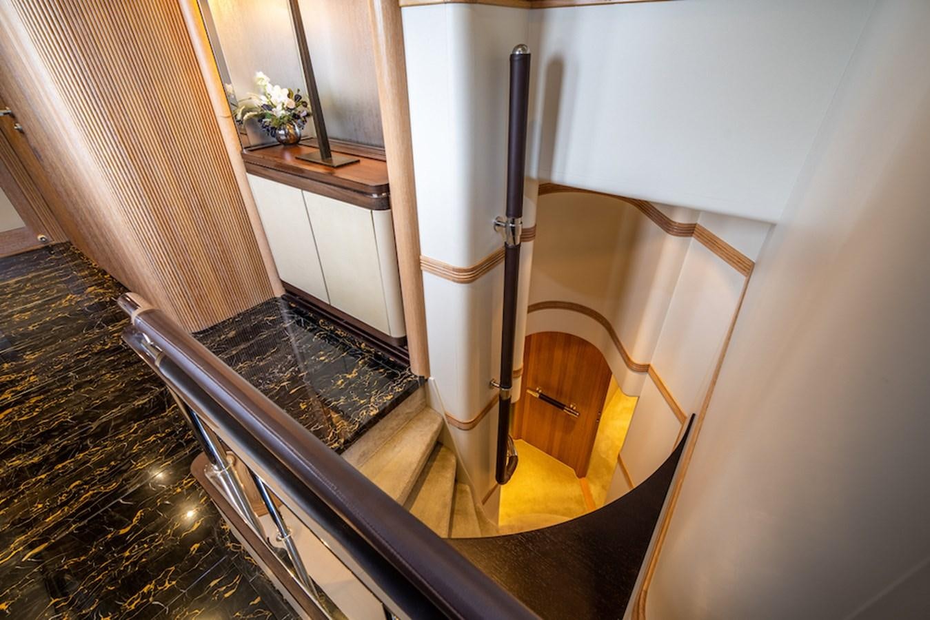 a hallway with a black railing aboard LA MASCARADE Yacht for Sale