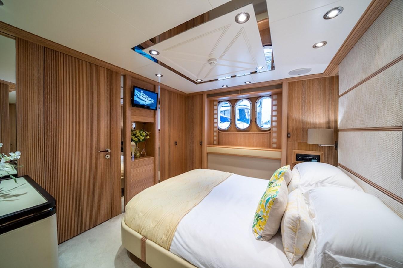 a room with a bed and a tv aboard LA MASCARADE Yacht for Sale