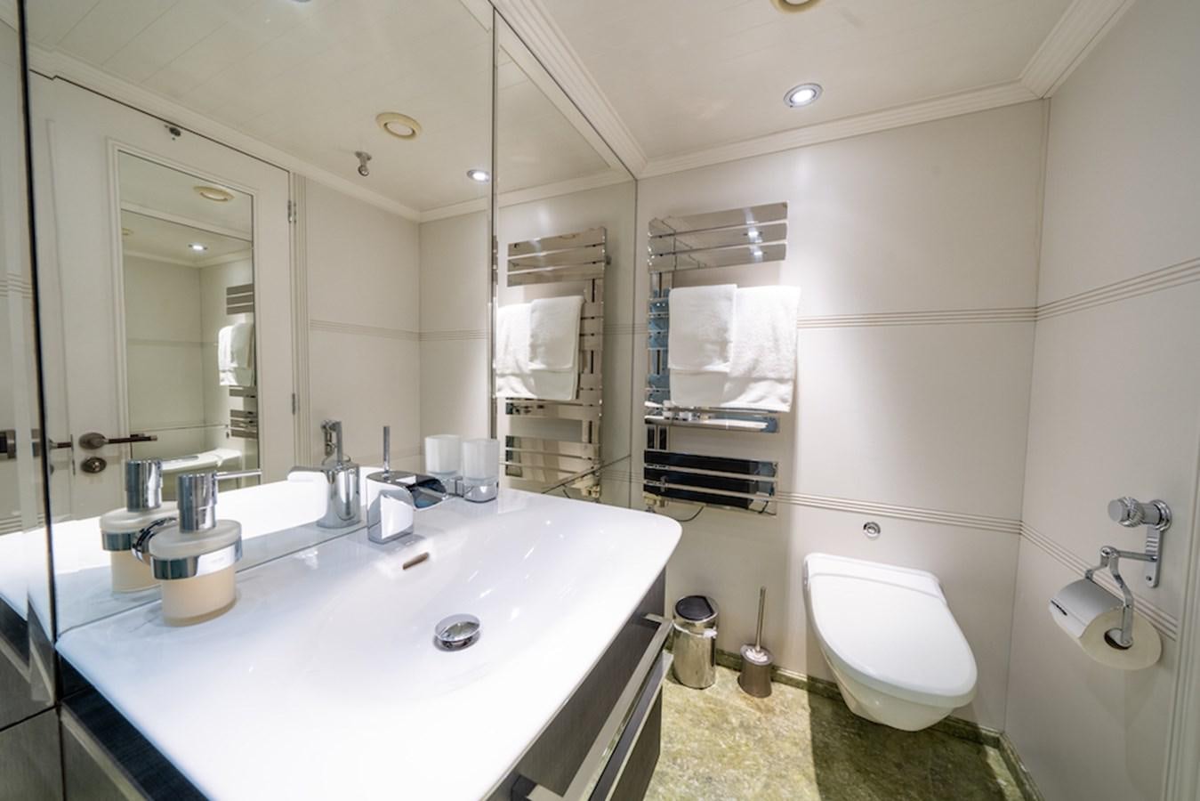 a bathroom with a sink toilet and a mirror aboard LA MASCARADE Yacht for Sale
