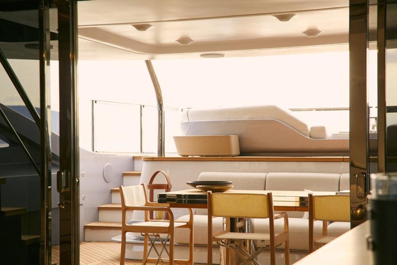 a room with tables and chairs aboard SHABBY Yacht for Sale