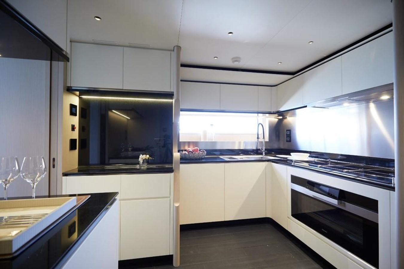 a kitchen with white cabinets aboard SHABBY Yacht for Sale