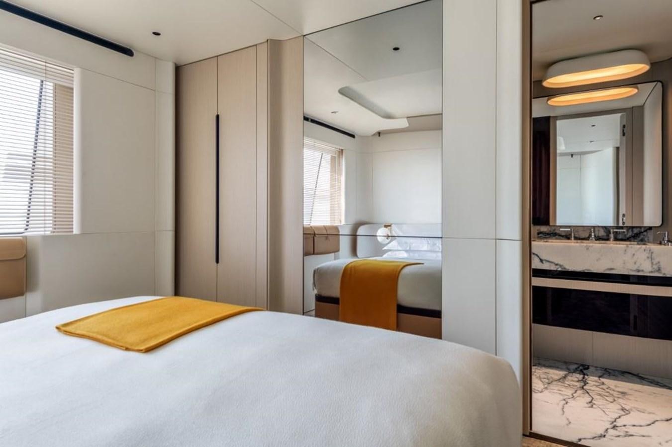 a bedroom with a bed and a desk aboard SHABBY Yacht for Sale