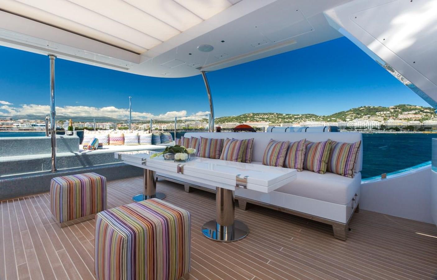 a couch and table on a deck aboard GALA Yacht for Sale