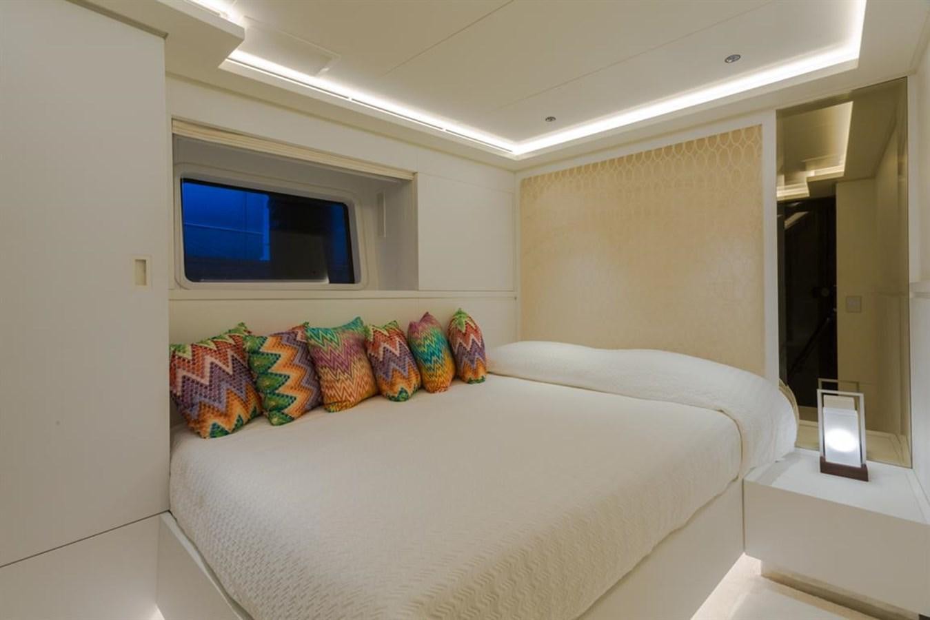 a bed with a white bed aboard GALA Yacht for Sale