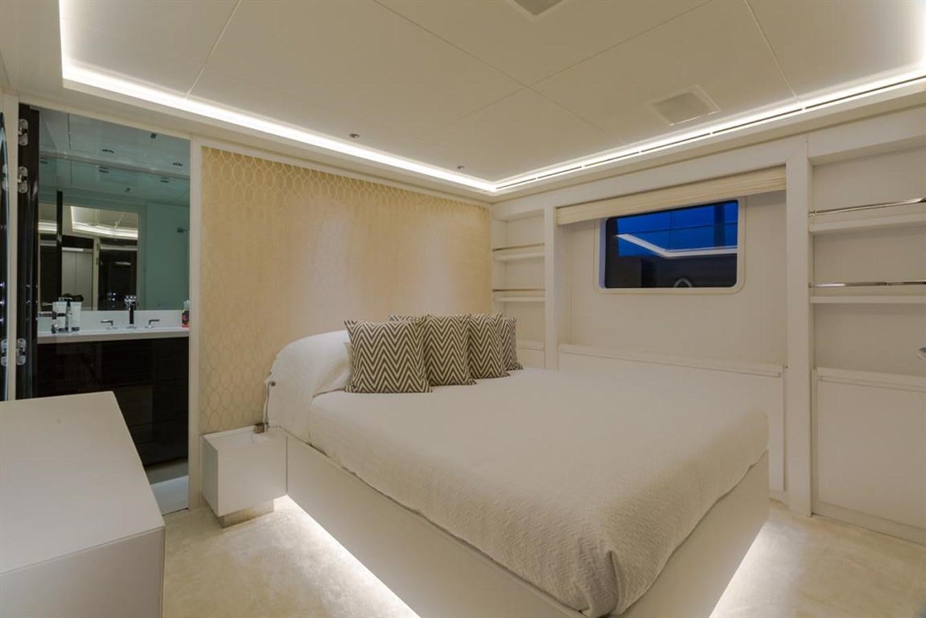a room with a bed and a tv on the wall aboard GALA Yacht for Sale