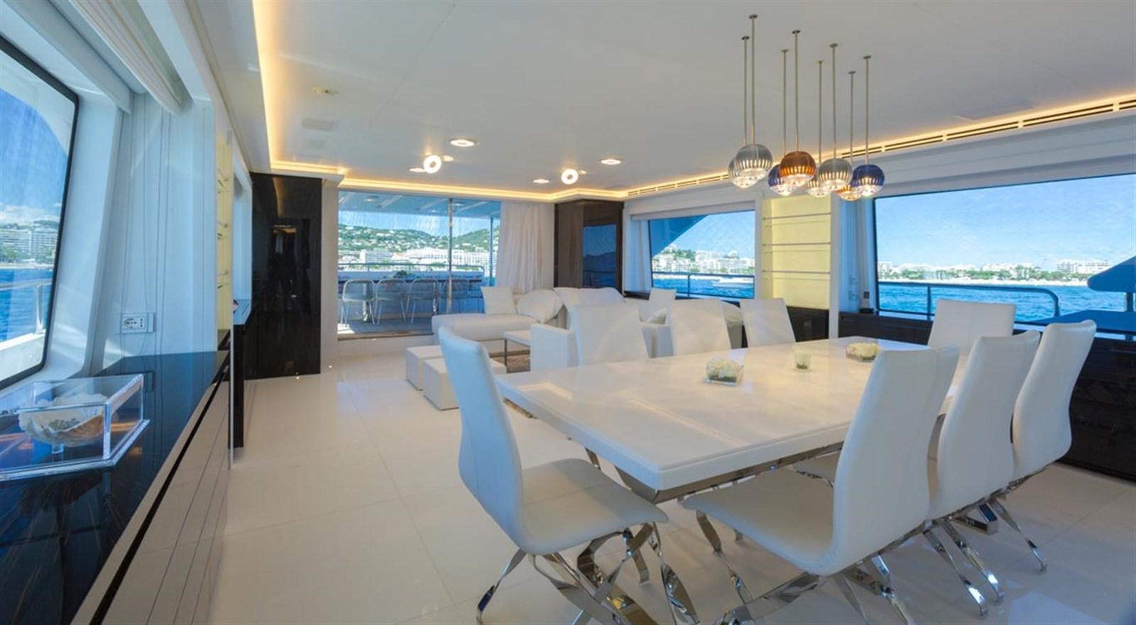 a large white dining room with a large window and a view of the ocean aboard GALA Yacht for Sale